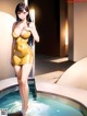 A woman in a yellow dress standing in a pool.