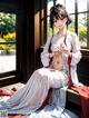 A woman in a white kimono sitting on a window sill.